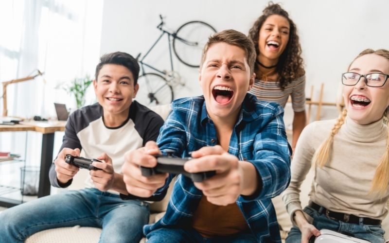 Young people very excitedly play video games