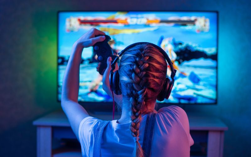 Young girl playing a video game enthusiastically