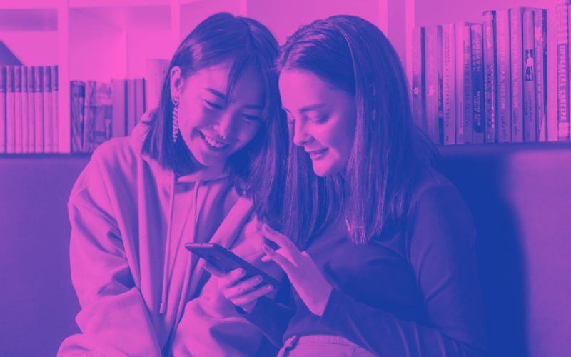 Tween girls looking at smartphone