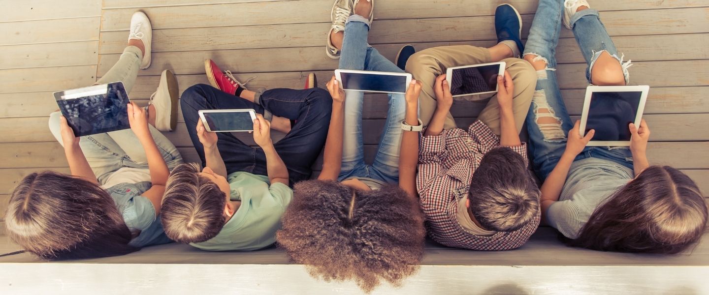 Top view of young people sitting with tablets