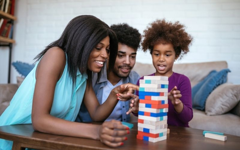 Family playing a tabletop falling-block game