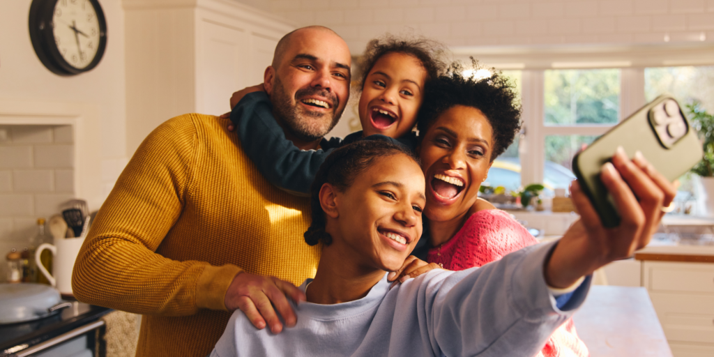 Four family members take a smiling selfie