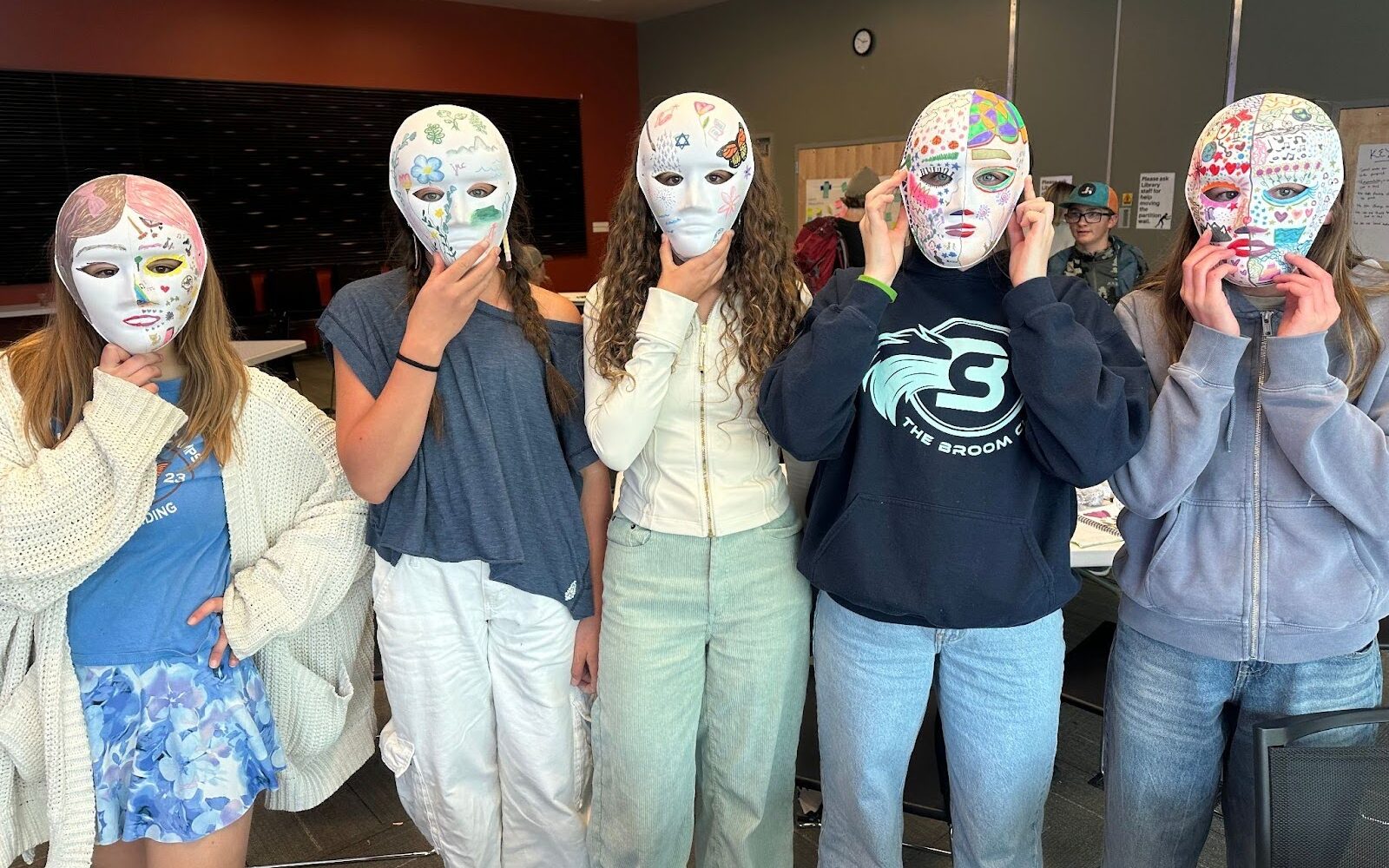 5 young people in decorated masks
