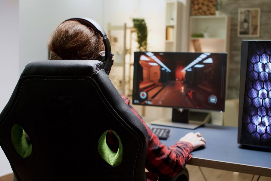 gamer youth in chair playing PC games