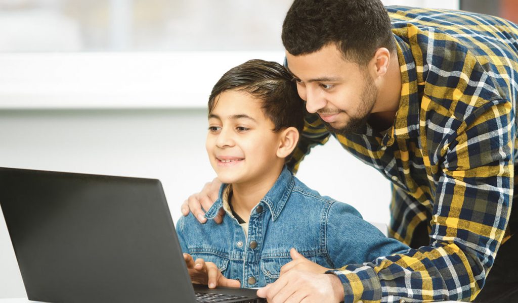 Father with child at laptop