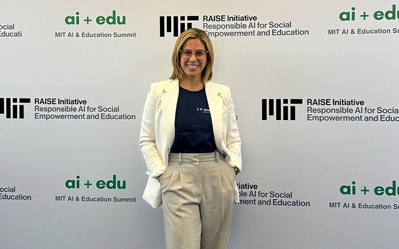 Brinleigh in front of a wall of MIT and ai+edu logos