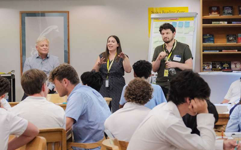 Michael, Kaitlin, and Sam presenting to students