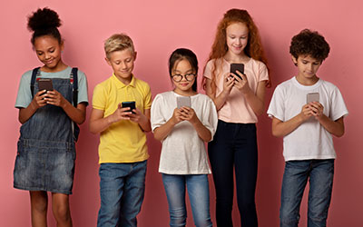 Five children looking at phones