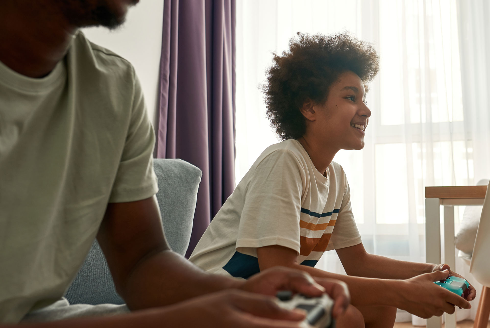 a young person and parent playing console games