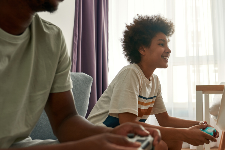 a young person and parent playing console games
