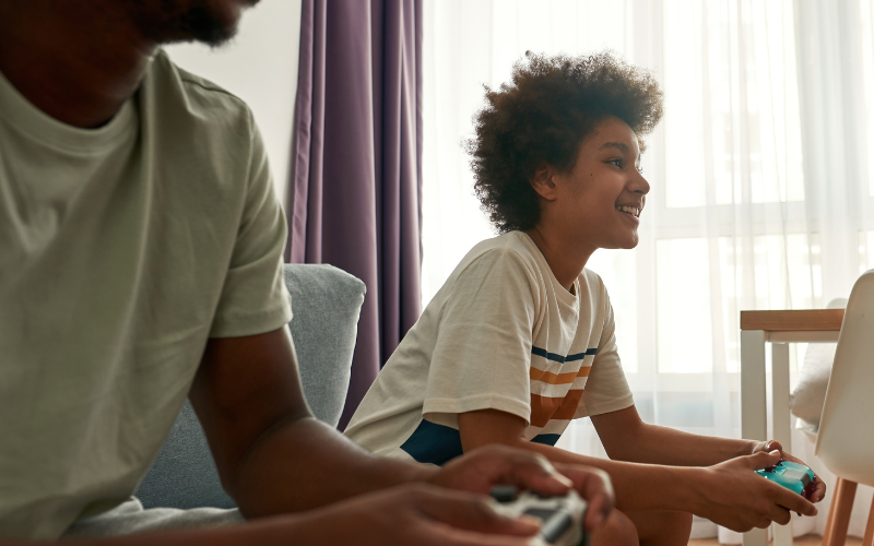 a young person and parent playing console games