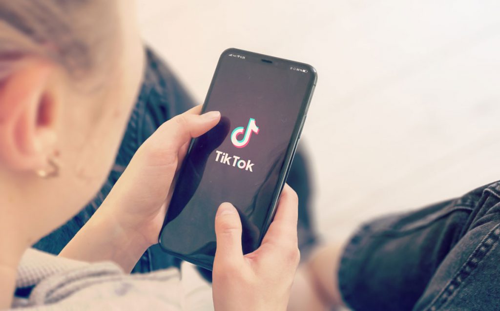 young person opening tiktok on phone