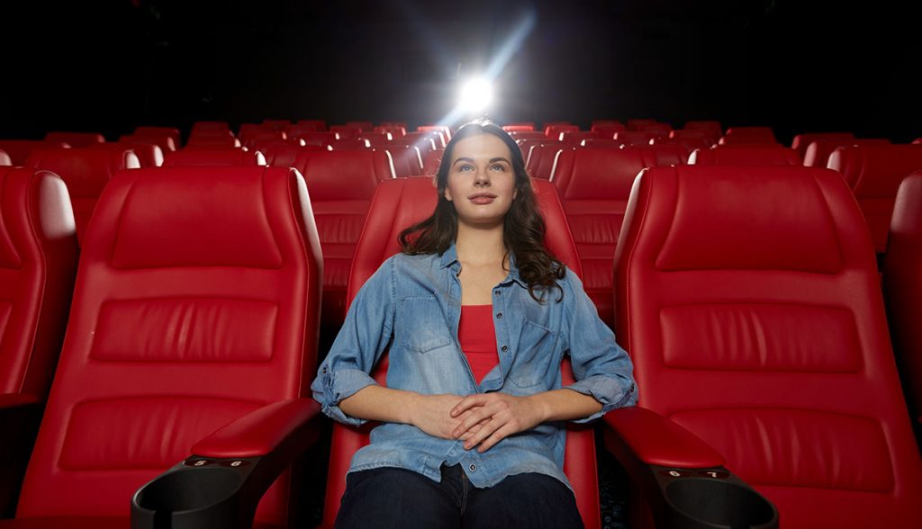 Young woman in an empty movie theater